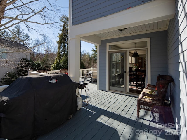 wooden deck with a grill