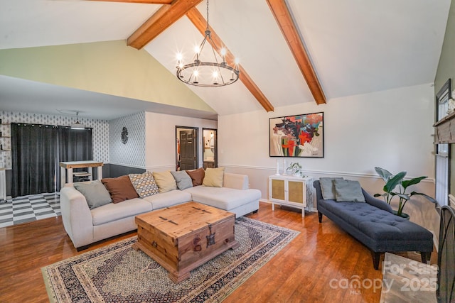 living room with beamed ceiling, high vaulted ceiling, hardwood / wood-style flooring, and a chandelier