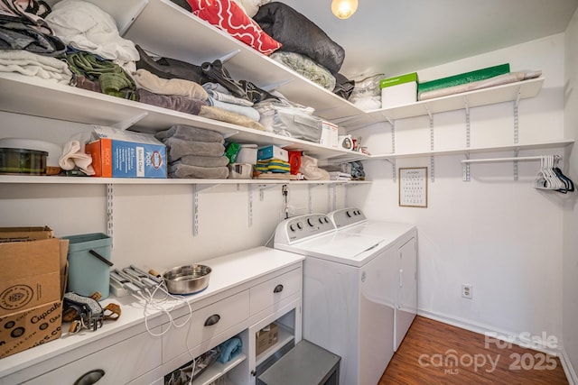 clothes washing area featuring independent washer and dryer and dark hardwood / wood-style flooring