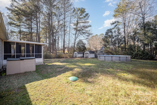 view of yard featuring a storage shed and a sunroom