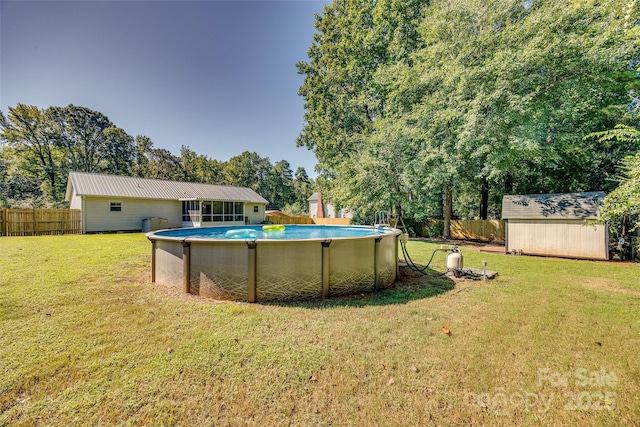 view of yard with a fenced in pool and a storage shed