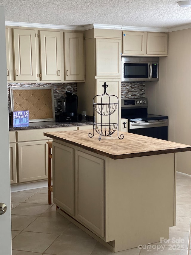 3474 Lake Wylie Dr, Rock Hill, SC 29732 - kitchen featuring butcher block countertops, decorative backsplash, appliances with stainless steel finishes, and a textured ceiling