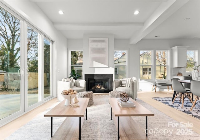 sunroom featuring beam ceiling