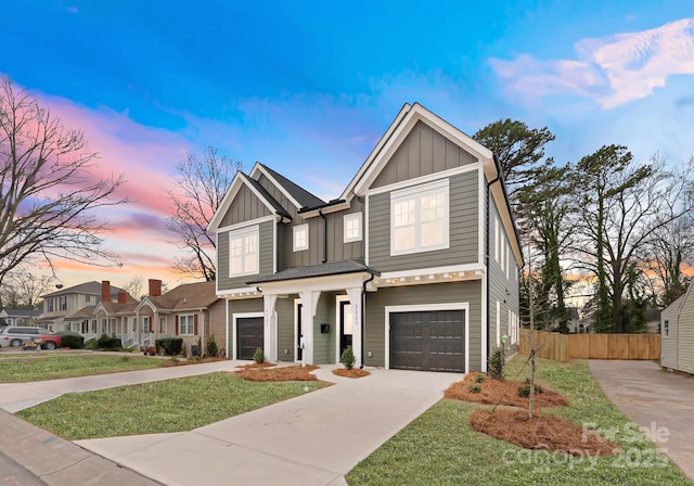 view of front of property featuring board and batten siding, concrete driveway, and an attached garage