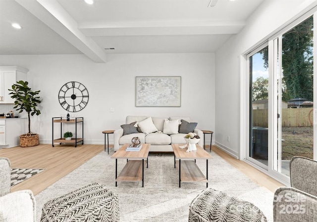 living room with light wood-style flooring, beam ceiling, recessed lighting, and baseboards