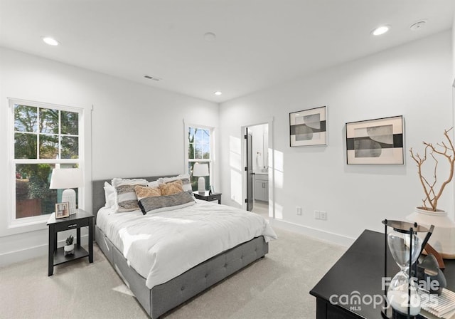 bedroom with light carpet, recessed lighting, and baseboards
