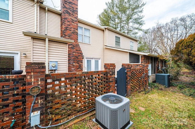 back of house featuring central AC