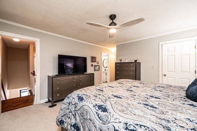 carpeted bedroom featuring ceiling fan, ornamental molding, connected bathroom, and a textured ceiling