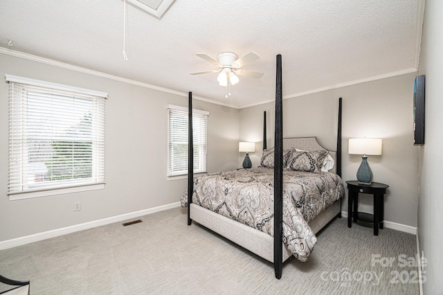 bedroom featuring ceiling fan, ornamental molding, light colored carpet, and a textured ceiling