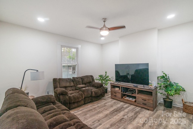 living room with ceiling fan and light hardwood / wood-style floors