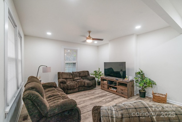 living room with light hardwood / wood-style floors and ceiling fan