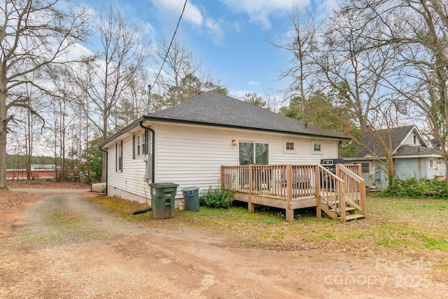 back of house with a deck