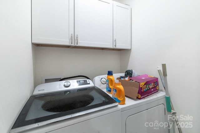 laundry room featuring cabinets and washing machine and clothes dryer