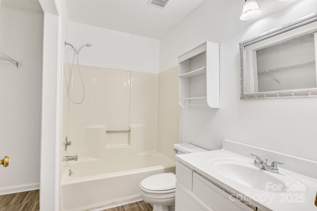 full bathroom with vanity, wood-type flooring, shower / tub combination, and toilet