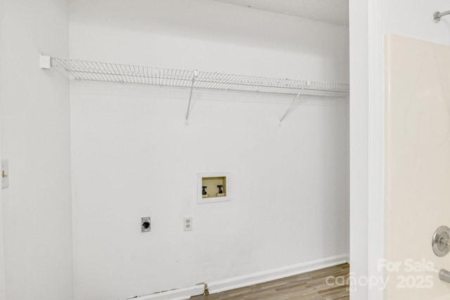 washroom with hookup for a washing machine, wood-type flooring, and electric dryer hookup