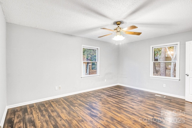 spare room featuring dark hardwood / wood-style floors, a textured ceiling, and ceiling fan