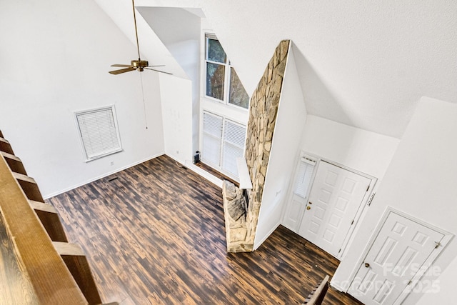 foyer entrance featuring ceiling fan, dark hardwood / wood-style floors, a textured ceiling, and high vaulted ceiling