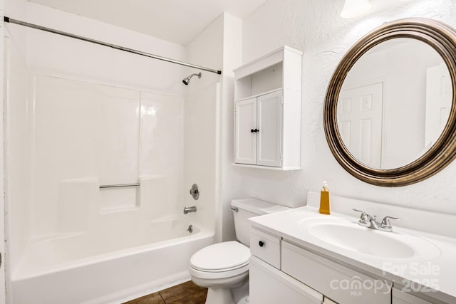 full bathroom featuring tile patterned flooring, vanity,  shower combination, and toilet