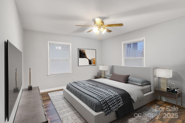 bedroom with hardwood / wood-style flooring and ceiling fan