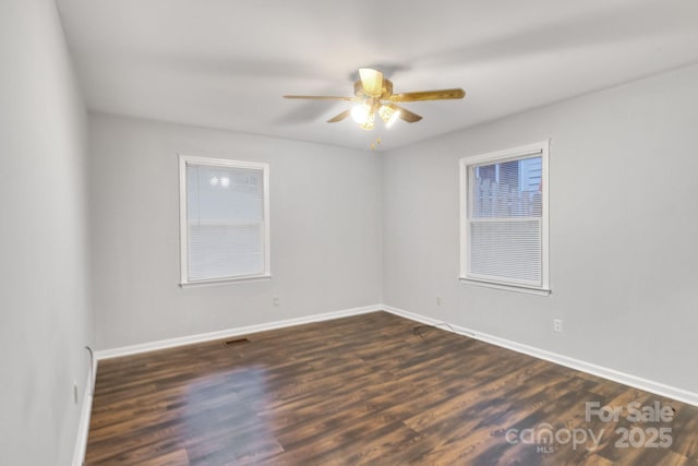 unfurnished room with dark hardwood / wood-style flooring and ceiling fan