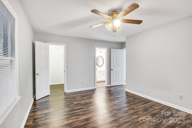 unfurnished bedroom with ceiling fan, ensuite bathroom, and dark hardwood / wood-style floors