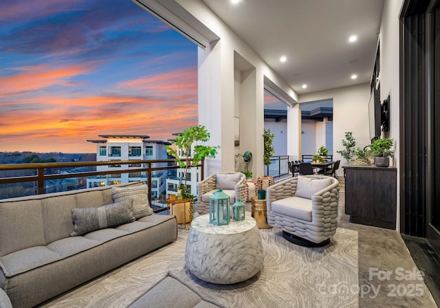 balcony at dusk with an outdoor hangout area