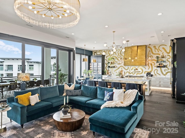 living room featuring dark hardwood / wood-style floors and an inviting chandelier