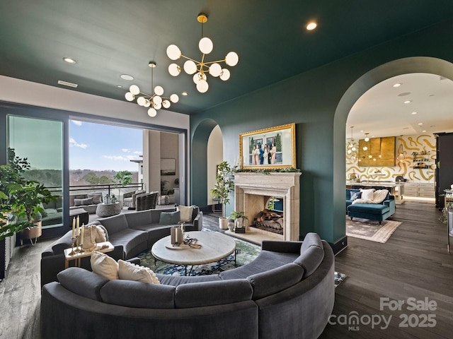 living room with hardwood / wood-style flooring and a notable chandelier