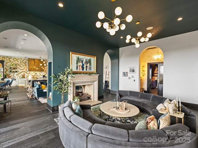 living room with dark hardwood / wood-style flooring and a notable chandelier