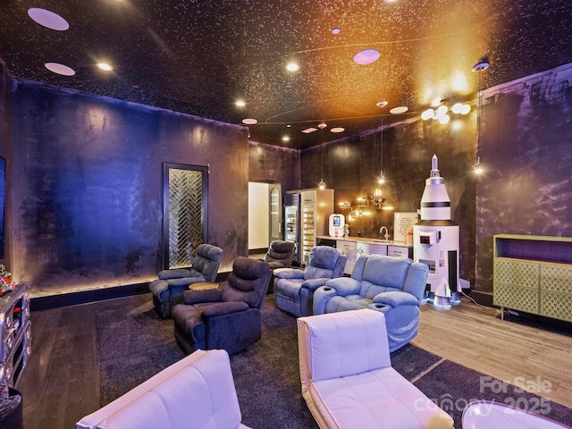 cinema room featuring wood-type flooring and sink