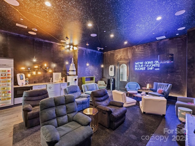 home theater room with sink and wood-type flooring