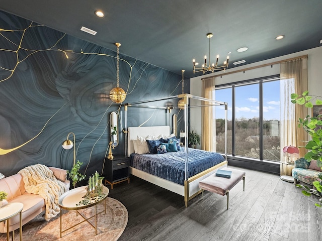 bedroom with hardwood / wood-style flooring and a notable chandelier