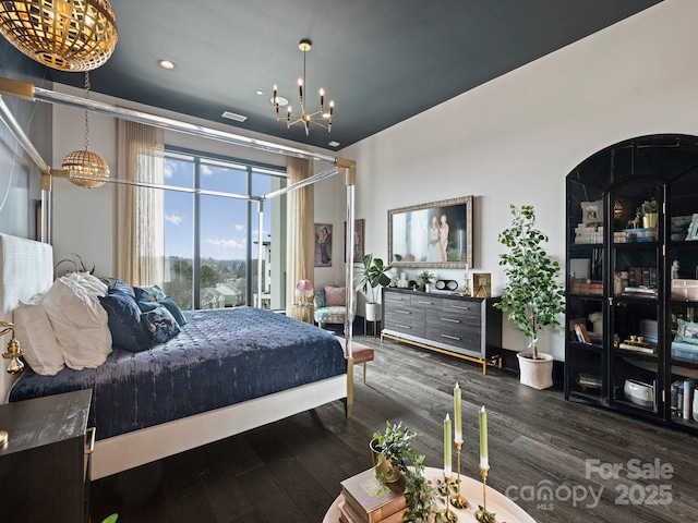 bedroom featuring dark hardwood / wood-style flooring and a chandelier