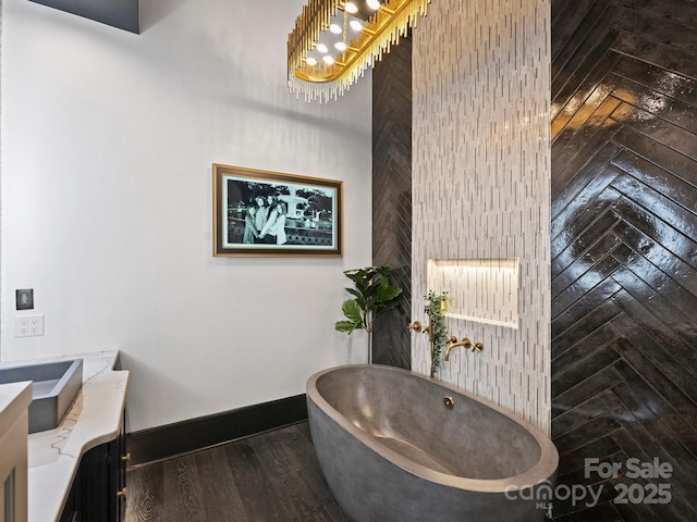 bathroom featuring vanity, a bathtub, and wood-type flooring