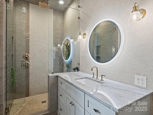 bathroom featuring vanity and an enclosed shower