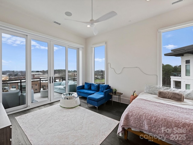 bedroom featuring dark wood-type flooring, ceiling fan, and access to exterior