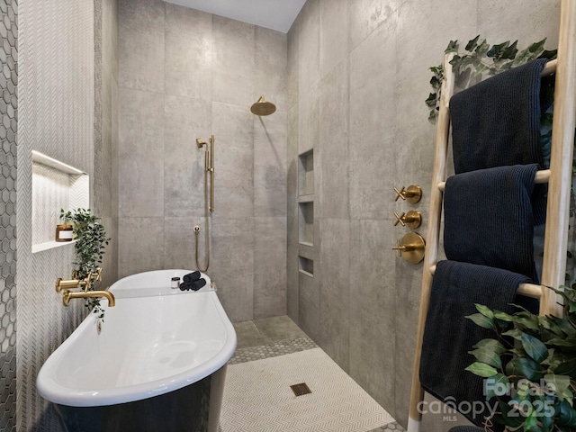 bathroom featuring tile walls, sink, and shower with separate bathtub