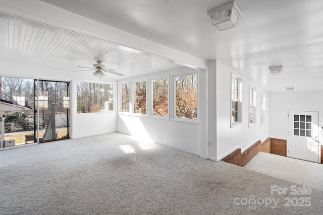 unfurnished sunroom with ceiling fan and beamed ceiling