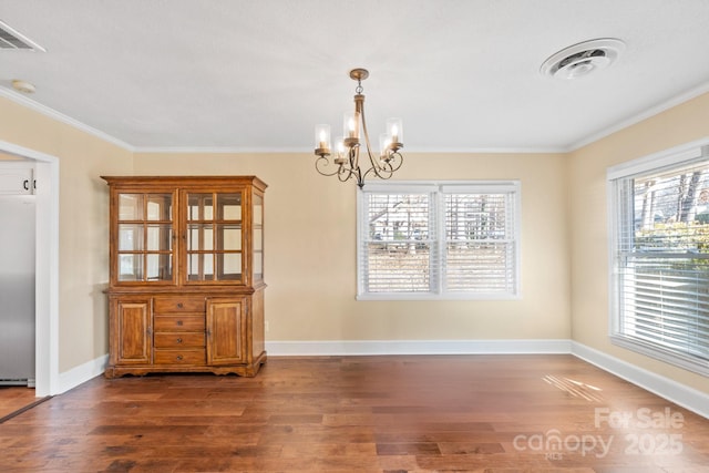 unfurnished dining area featuring crown molding, a notable chandelier, and dark hardwood / wood-style flooring