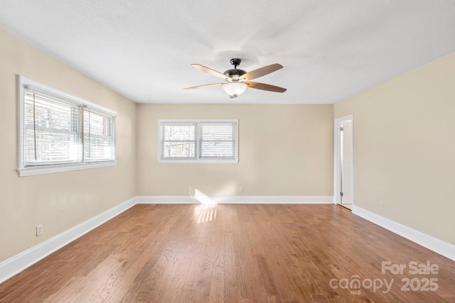 spare room with hardwood / wood-style flooring and ceiling fan