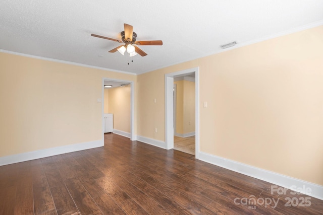 unfurnished room with a textured ceiling, dark wood-type flooring, ornamental molding, and ceiling fan