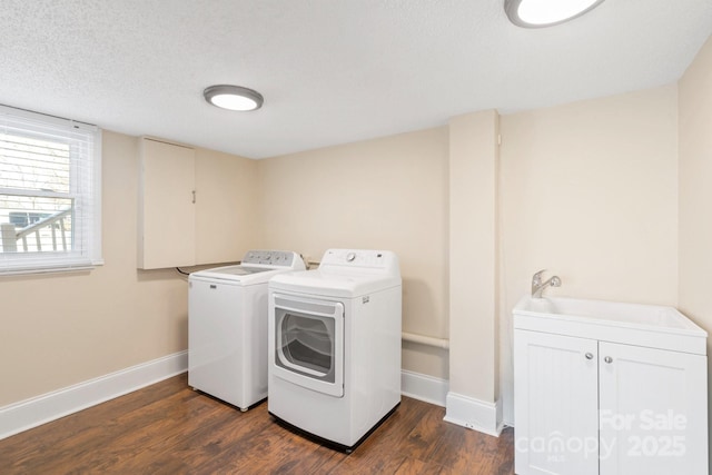 laundry area featuring dark wood-type flooring, sink, cabinets, a textured ceiling, and independent washer and dryer