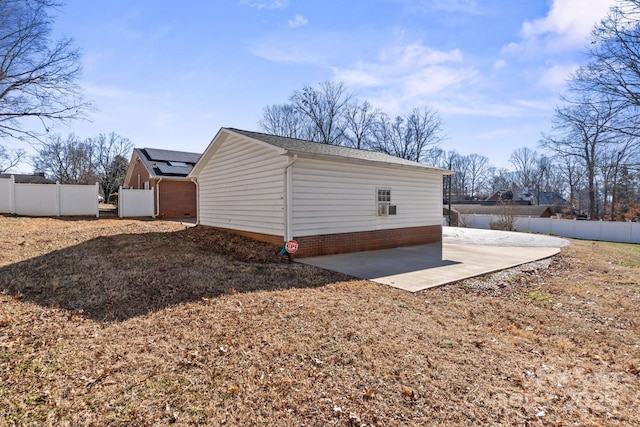 view of side of home featuring a patio area and solar panels