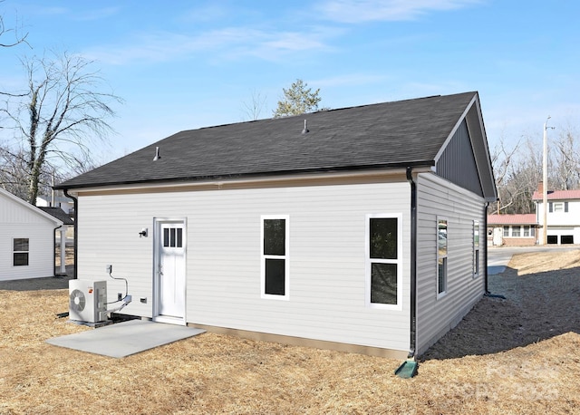 rear view of property featuring ac unit and a patio