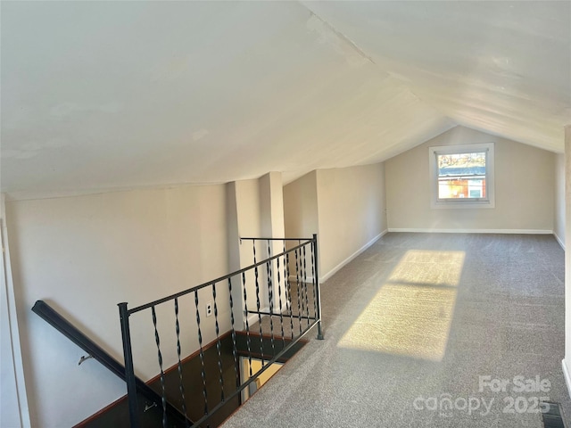 bonus room with lofted ceiling and carpet floors