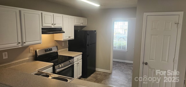 kitchen featuring white cabinetry, black refrigerator, stainless steel electric range oven, and sink