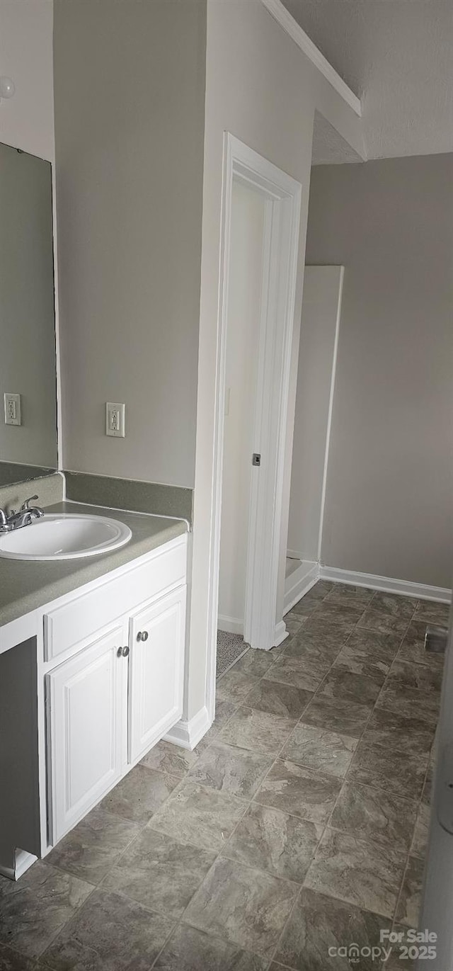 bathroom with vanity and a shower