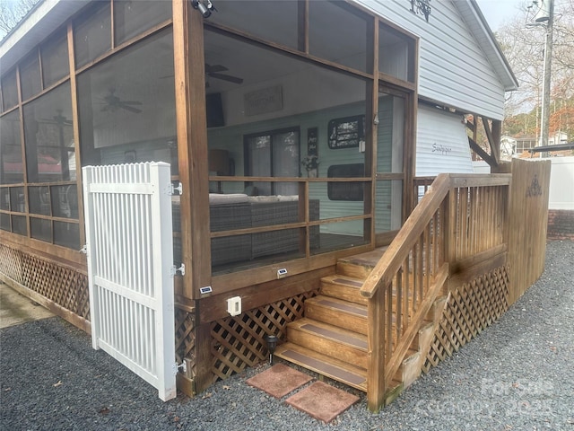 doorway to property featuring ceiling fan