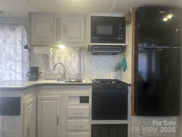 kitchen featuring white cabinetry, sink, tasteful backsplash, and black appliances