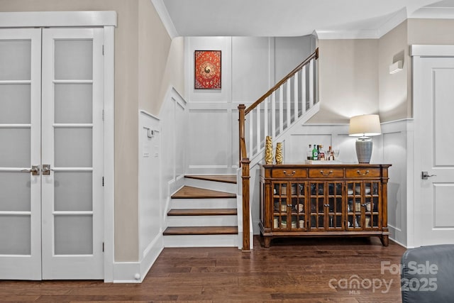 staircase with hardwood / wood-style flooring and ornamental molding